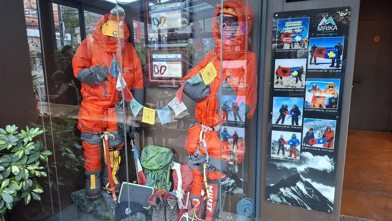 The orange expedition suits and summit photos on display at the lounge